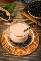 Black sesame milk tea with mixed beans and seeds on rustic wooden table background
