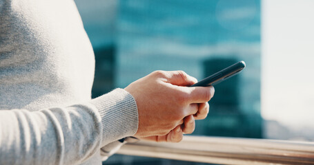 Businessman, hands and typing with phone on balcony for trading account, economy news or research. City, trader and smartphone at office for stock market portfolio, online investment or communication