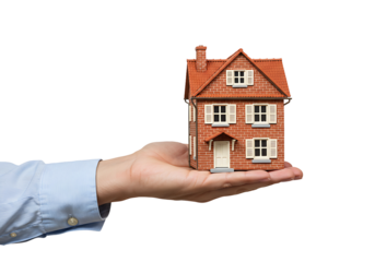 Hand holding a small house model isolated on transparent background