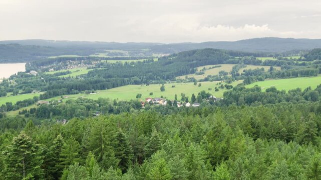 View of rolling hills and forest in the countryside during a calm overcast day in summer at the Vltava Reseroir in Lipno nad Vltavou