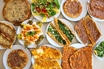 Delicious meat kebab with fresh vegetable salad served with variety of Turkish dishes and appetizers. Top view of assorted Turkish food and meze, tasty and healthy Mediterranean cuisine. Top view.