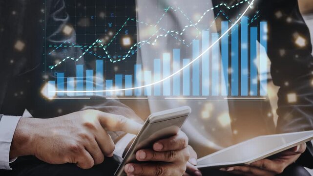 Modern workspace image featuring hands holding a smartphone and tablet with financial charts and graphs, depicting data analysis and growth strategies in business. Copula