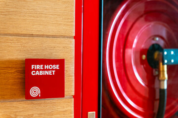 Fire Safety Concept, Fire extinguisher, Fire protection cabinet with fire hydrant and hose reel in public building corridor.