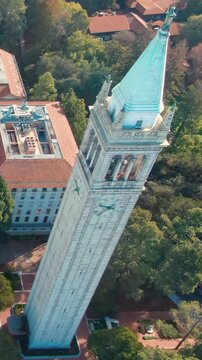 Aerial view of UC Berkeley's iconic Campanile clock tower and campus buildings, showcasing the university's architecture and urban setting in California, USA.