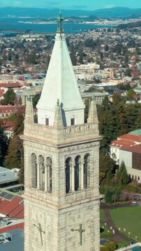 Aerial view of UC Berkeley's iconic Campanile clock tower and campus buildings, showcasing the university's architecture and urban setting in California, USA.