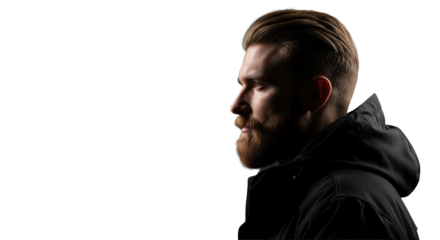 Young caucasian man with beard, short blonde hair, dark hooded jacket, stoic gaze left on deep black background, high-contrast cinematic lighting. Concept of inner strength