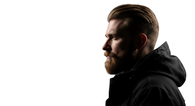 Young caucasian man with beard, short blonde hair, dark hooded jacket, stoic gaze left on deep black background, high-contrast cinematic lighting. Concept of inner strength