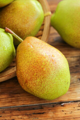 Fresh Organic Pears in Wooden Basket on Rustic Wood Table
