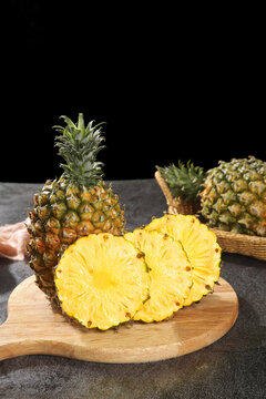 Fresh Zhanjiang Xuwen Pineapples with Golden Flesh Slices on Wooden Board