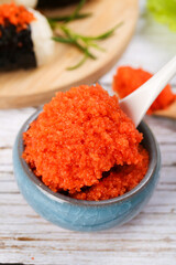 Fresh Orange Fish Roe Caviar for Japanese Sushi Cuisine in Ceramic Spoon