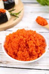 Fresh Orange Fish Roe Caviar in Bowl with Korean Sushi Rolls Background