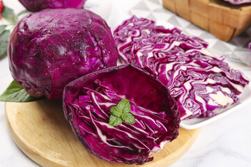 Fresh Purple Red Cabbage Heads Whole and Sliced on Wooden Cutting Board