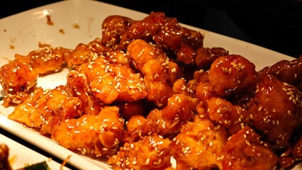 Fried crispy salmon with sauce, tender inside. Savory dish.