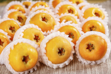 Fresh Yunnan Loquat Fruits in Protective Packaging on Bamboo Mat - Premium Asian Tropical Produce