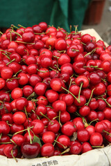 Fresh Red Cherries Stacked in Market Basket - Seasonal Fruit Harvest Display