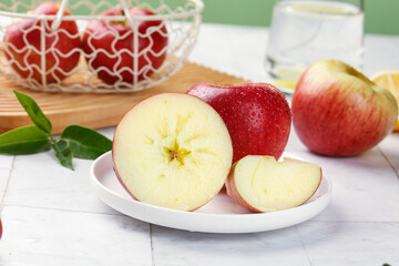 Fresh Red Apples with Heart-Shaped Core and Dew Drops on White Plate