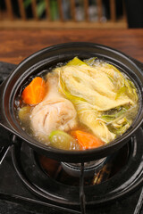 Chinese Hot Pot with Fresh Vegetables and Meat in Black Ceramic Pot - Healthy Sulfur-Free Ingredients