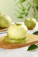 Fresh Green Apples from Shaanxi Shandong China on Wooden Board with Tropical Leaves