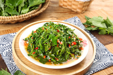 Fresh Wild Amaranth Greens Salad with Garlic and Chili on Wooden Plate - Organic Cold Vegetable Dish