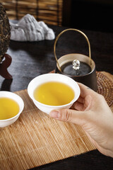 Traditional Chinese Puerh Tea Ceremony with Golden Tea Cup and Authentic Yunnan Tea Service Setup