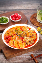 Spicy Seafood Stew with Prawns Conch and Shellfish in Red Broth on Wooden Serving Board
