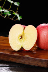 Fresh Cut Fuji Apple from Yantai Shandong China Showing White Pulp and Seeds on Wooden Board