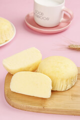 Handmade Steamed Cake Slices on Wooden Board with Coffee Cup Pink Background