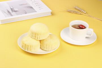 Handmade Steam Buns with Tea Cup on Yellow Background - Traditional Asian Dessert and Hot Beverage Setup