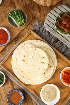 Fresh Flour Tortillas with Cooking Ingredients on Rustic Wood Table - Mexican Food Preparation