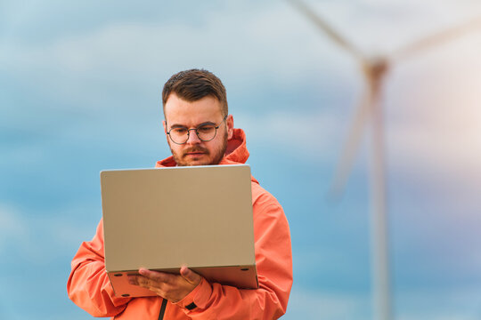 Young man using laptop outdoors