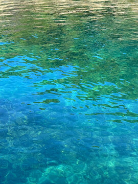 Crystal clear emerald sea water background vertical.