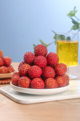 Fresh Lychee Fruits from Lingshan Zengcheng Gaozhou Regions on White Plate with Tea - Tropical Asian Fruit Display