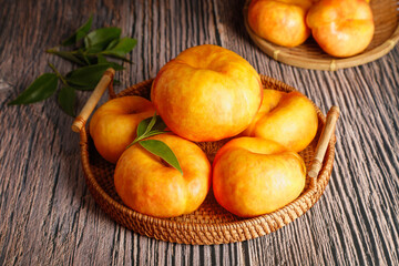 Fresh Shandong Yimeng Mountain Peaches in Wicker Baskets on Rustic Wood Background
