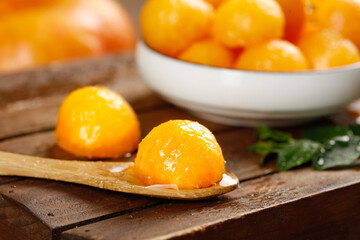 Fresh Cut Yellow Peach Pieces from Yimeng Mountain Shandong China on Wooden Spoon