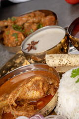 Kolhapuri chicken Thali is a popular Indian asian food platter consists of poultry meat, chikan sukka bhakri, rice, salad tambda padhra rassa 