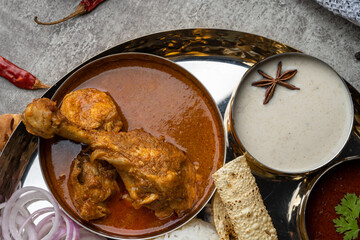 Kolhapuri chicken Thali is a popular Indian asian food platter consists of poultry meat, chikan...