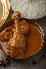 Kolhapuri chicken Thali is a popular Indian asian food platter consists of poultry meat, chikan sukka bhakri, rice, salad tambda padhra rassa 