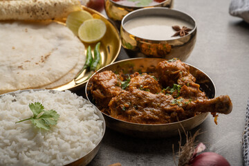 Kolhapuri chicken Thali is a popular Indian asian food platter consists of poultry meat, chikan sukka bhakri, rice, salad tambda padhra rassa 