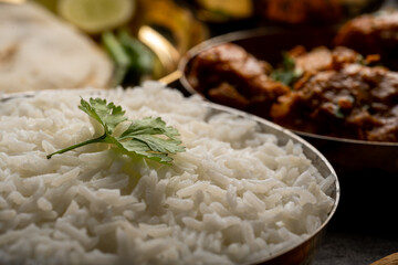 Kolhapuri chicken Thali is a popular Indian asian food platter consists of poultry meat, chikan sukka bhakri, rice, salad tambda padhra rassa 