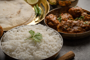 Kolhapuri chicken Thali is a popular Indian asian food platter consists of poultry meat, chikan sukka bhakri, rice, salad tambda padhra rassa 