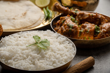 Kolhapuri chicken Thali is a popular Indian asian food platter consists of poultry meat, chikan sukka bhakri, rice, salad tambda padhra rassa 