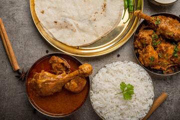 Kolhapuri chicken Thali is a popular Indian asian food platter consists of poultry meat, chikan sukka bhakri, rice, salad tambda padhra rassa 