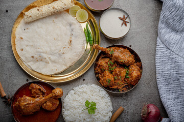 Kolhapuri chicken Thali is a popular Indian asian food platter consists of poultry meat, chikan sukka bhakri, rice, salad tambda padhra rassa 
