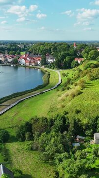 Lake Talsi (Lake Martinelli) With Town Centre Houses And Promenade In Talsi, Latvia. - aerial vertical shot