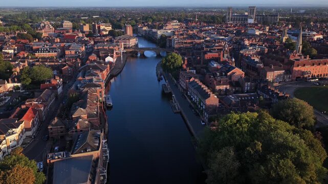 Aerial video of York city with River Ouse, Clifford&rsquo;s Tower, and York Minster at sunrise.