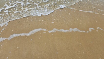 Sea water wave and sand beach with seashell background for decoration on summer holiday and coastal concept.