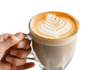 Hand gripping a glass mug of hot cappuccino with latte art, transparent background