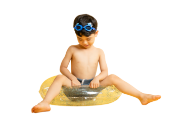 Asian young boy is sitting on a swim ring, wearing swim goggles, preparing for a fun day at the pool on PNG