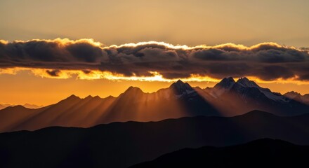 Dramatic Golden Hour: Crepuscular Rays Illuminate Snow-Capped Mountains at Sunset