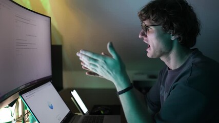 Young man gestures actively in front of computer discussing strategy with artificial intelligence symbolizing digital planning modern analytics innovative technology and online learning - Powered by Adobe